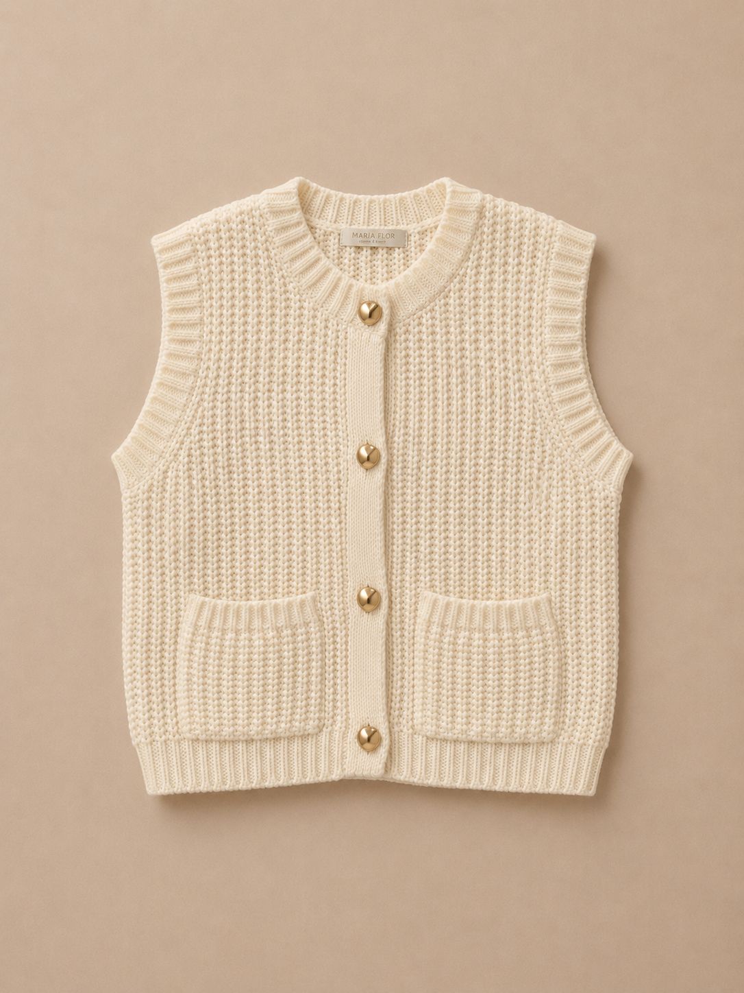 Knitted vest with gold buttons on a beige background